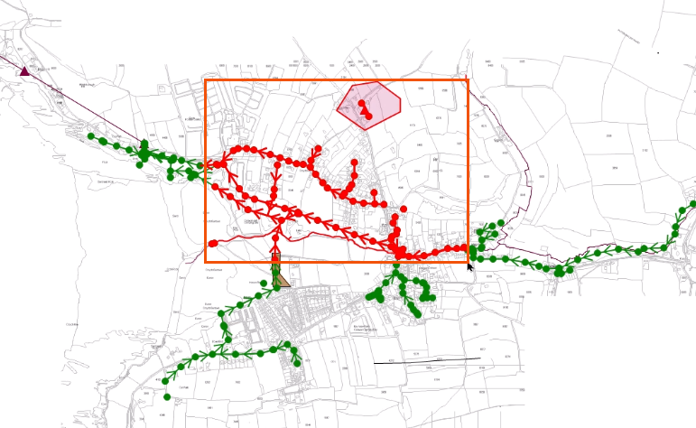 In the GeoPlan, the rectangular area being drawn represented by a red box, with all network objects inside the area selected and displayed in red.