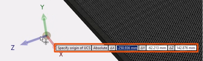 The UCS being positioned using coordinates, which are entered and highlighted in red.