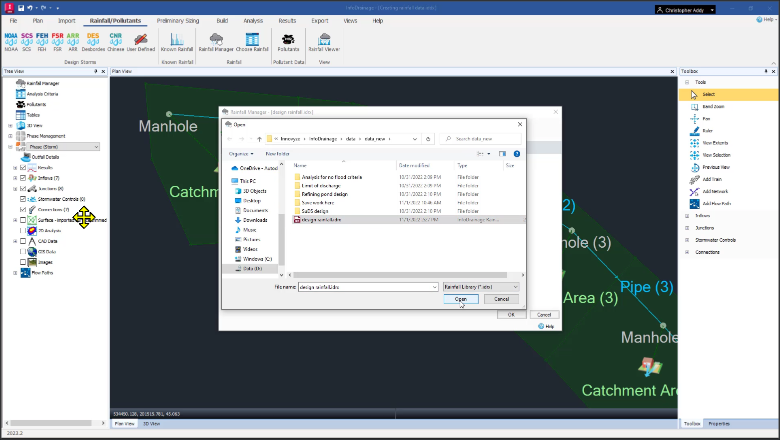 The InfoDrainage interface, with the Rainfall Manager open behind the Open dialog box. The rainfall study file has been chosen and the user is about to click Open.