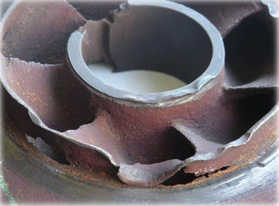 An image of a worn impeller with structural damage.