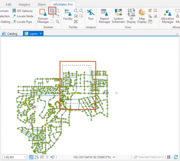 The Domain panel in the InfoWater Pro tab on the ribbon, with the Enlarge Domain icon highlighted, and the selection highlighted in the map