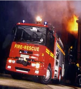 A stock image of a fire and rescue truck at the scene of a fire.