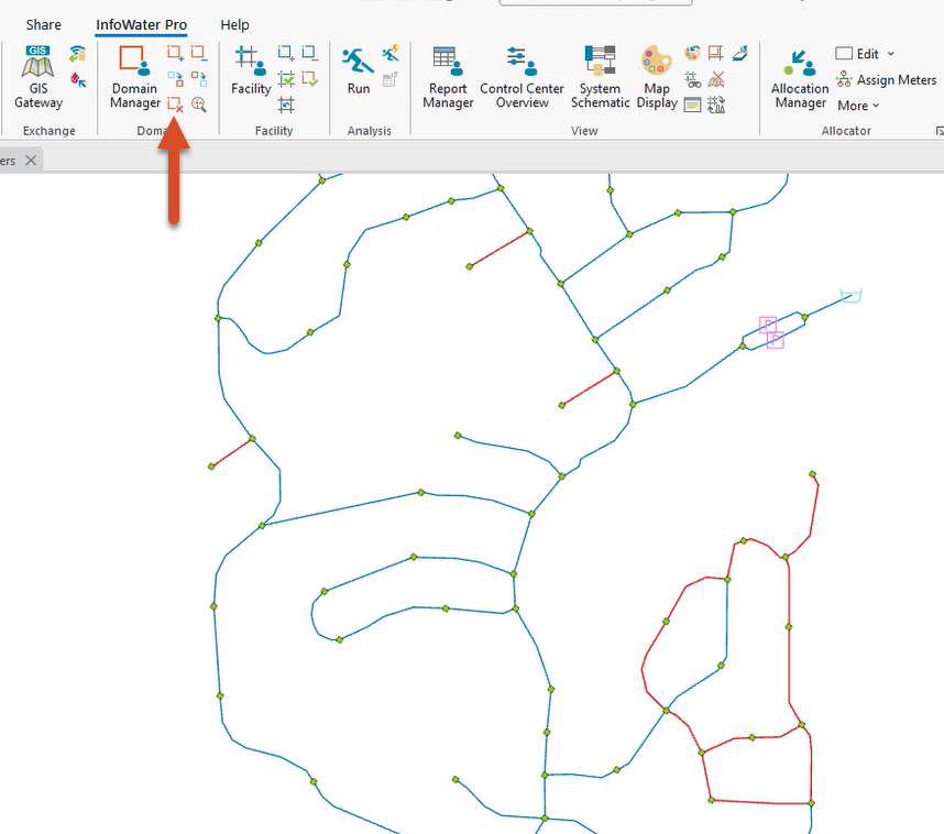 The map view zoomed to the domain of 4-inch pipes, and in the InfoWater Pro ribbon, Domain panel, the Clear Domain button called out with a red arrow.