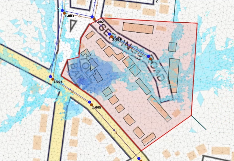 In a meshed 2D model with results generated, a 2D results polygon enclosing an area of buildings and a road that shows flooding.